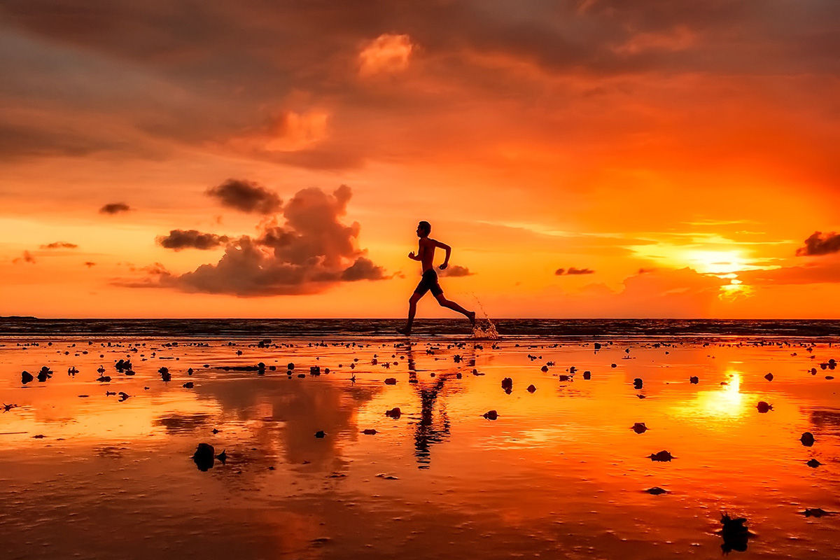 Man Exercising on Beach at Sinset