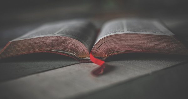 Desaturated Photo of Open Bible with Red Bookmark