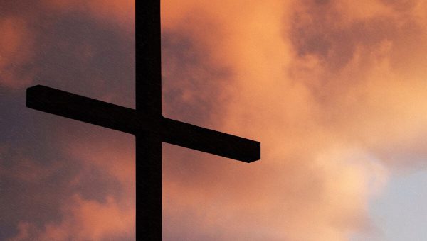 Cross with Clouds at Sunset in Background