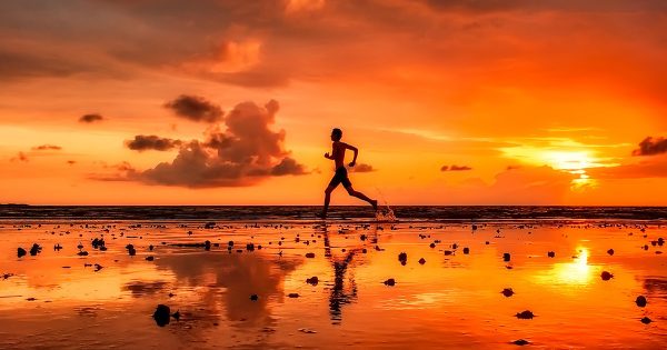 Man Exercising on Beach at Sinset